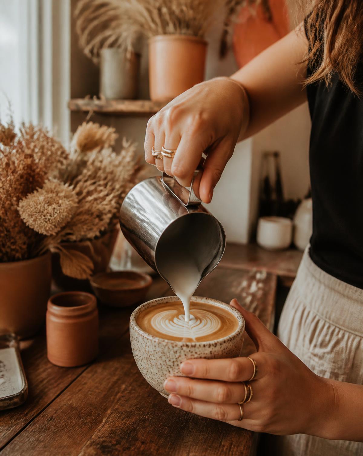 A barista pouring coffee at Inti Café